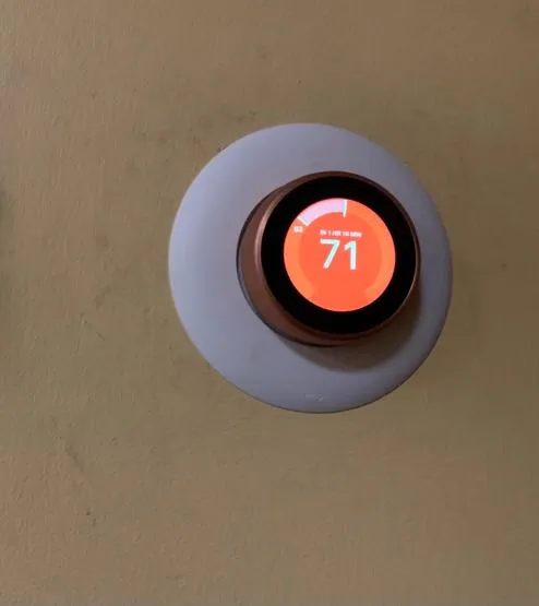 Smart thermostat in a modern home, highlighting energy efficiency and modern living