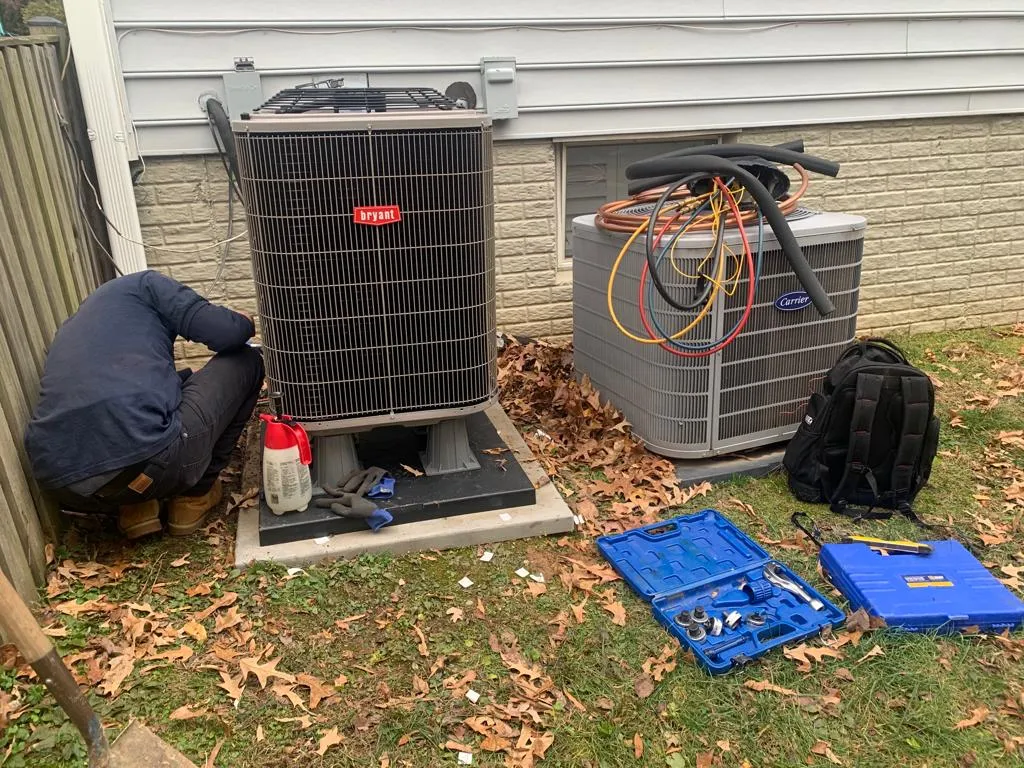 Understanding the Key Differences: Local HVAC Contractors vs. Larger Companies in Fairfax 2 HVAC contractor explaining transparent pricing to a homeowner