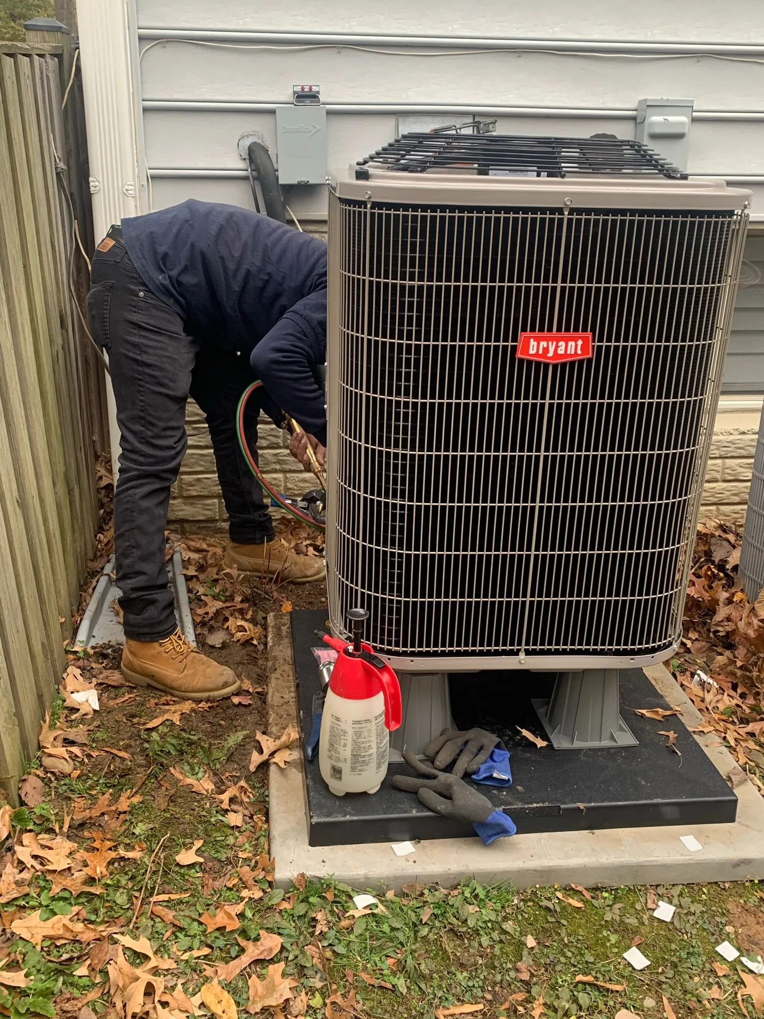 Technician responding to emergency AC repair at night with flashlight